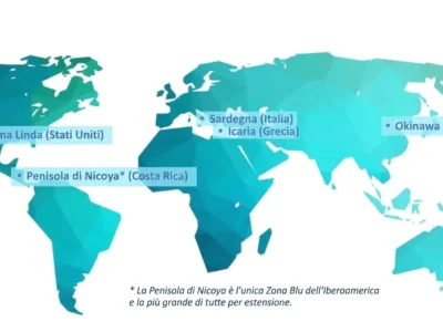 Mappa mondiale che evidenzia le Zone Blu: Loma Linda, Sardegna, Icaria, Okinawa e Nicoya; tonalità blu e verdi.